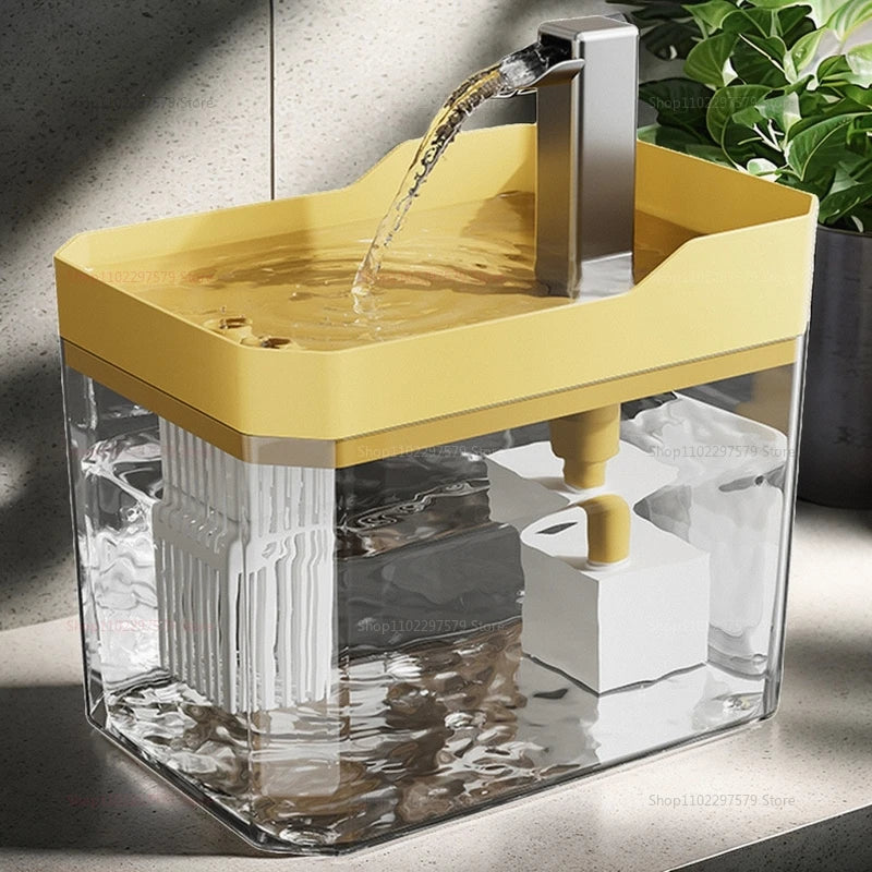 Yellow and clear pet water fountain with water flowing, placed on a surface.