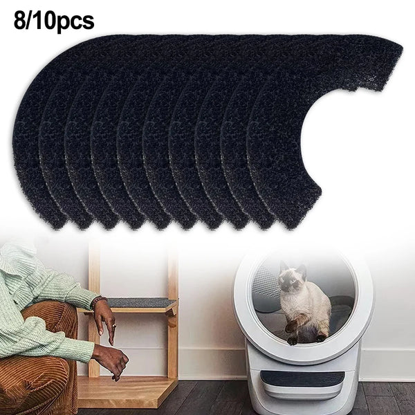 Set of black pet hair removal pads with a chair and pet litter box in the background.
