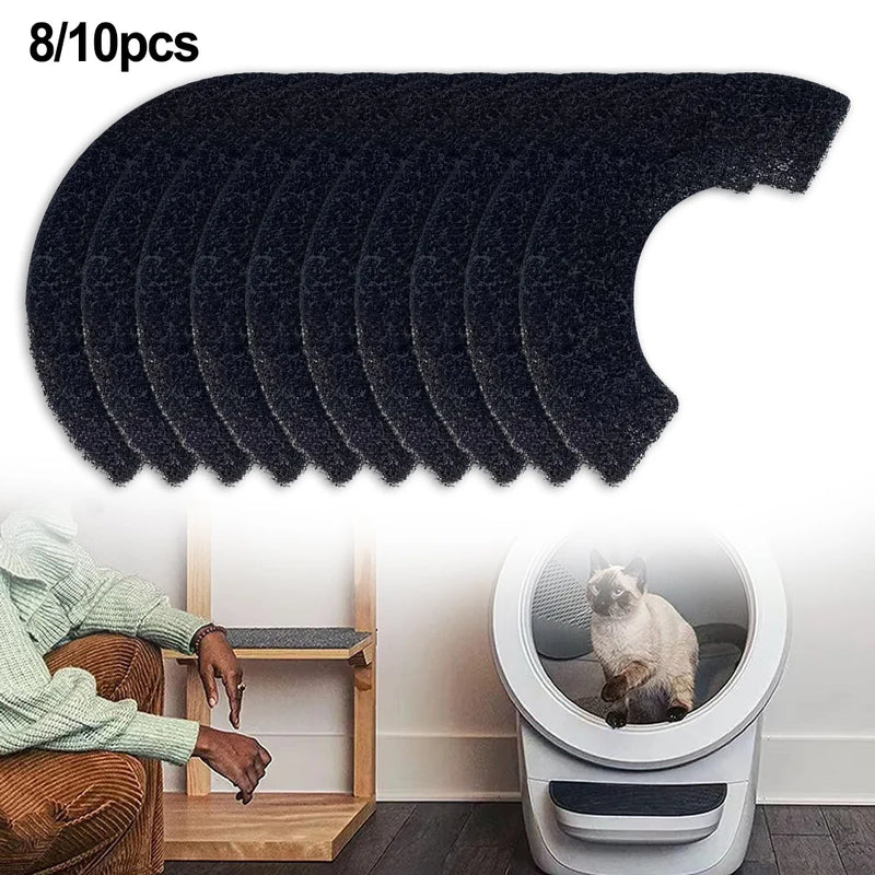Set of black pet hair removal pads with a chair and pet litter box in the background.
